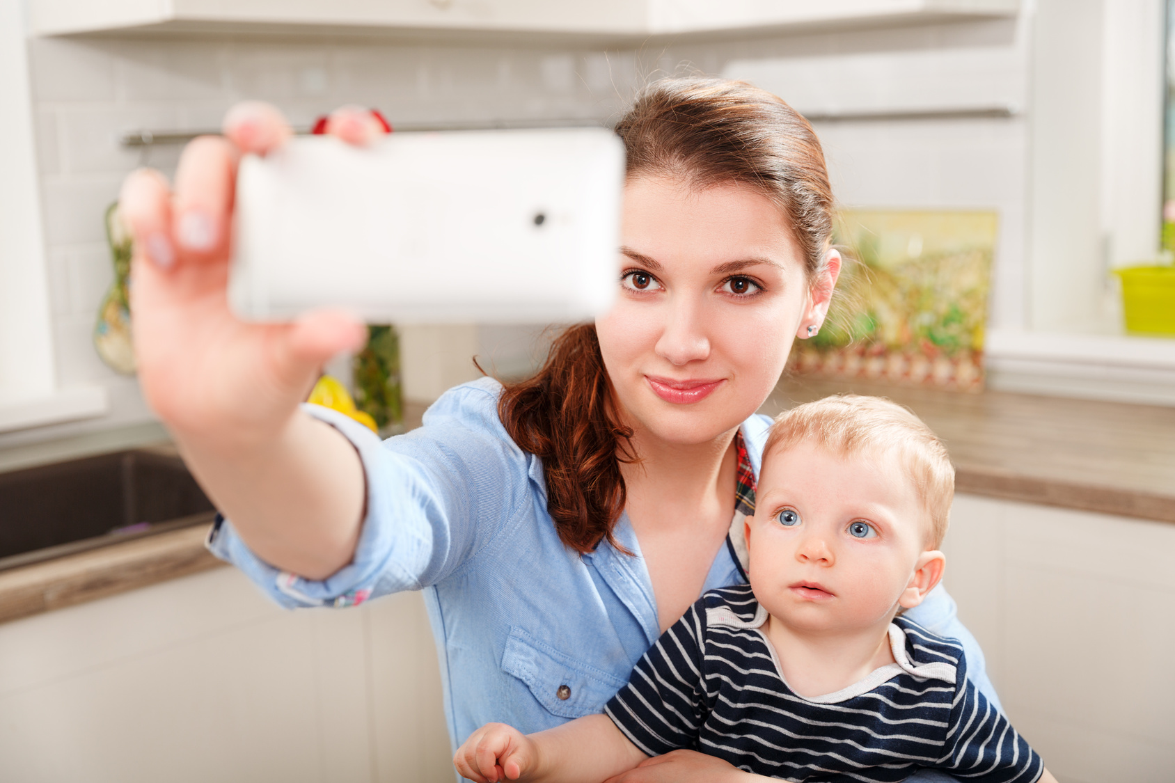 Mother and baby photographing selfie themselves by mobile
